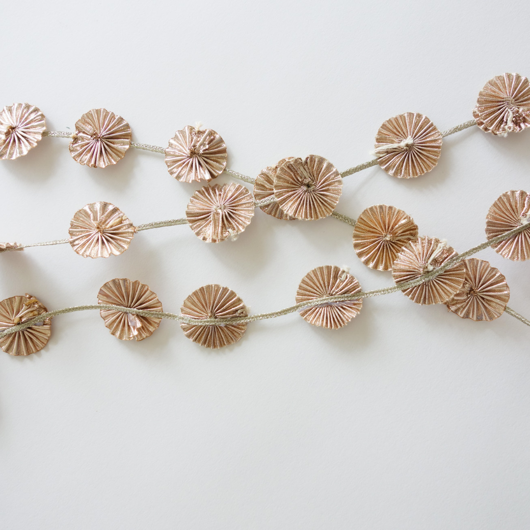 Flatlay of gota strands layered on one another