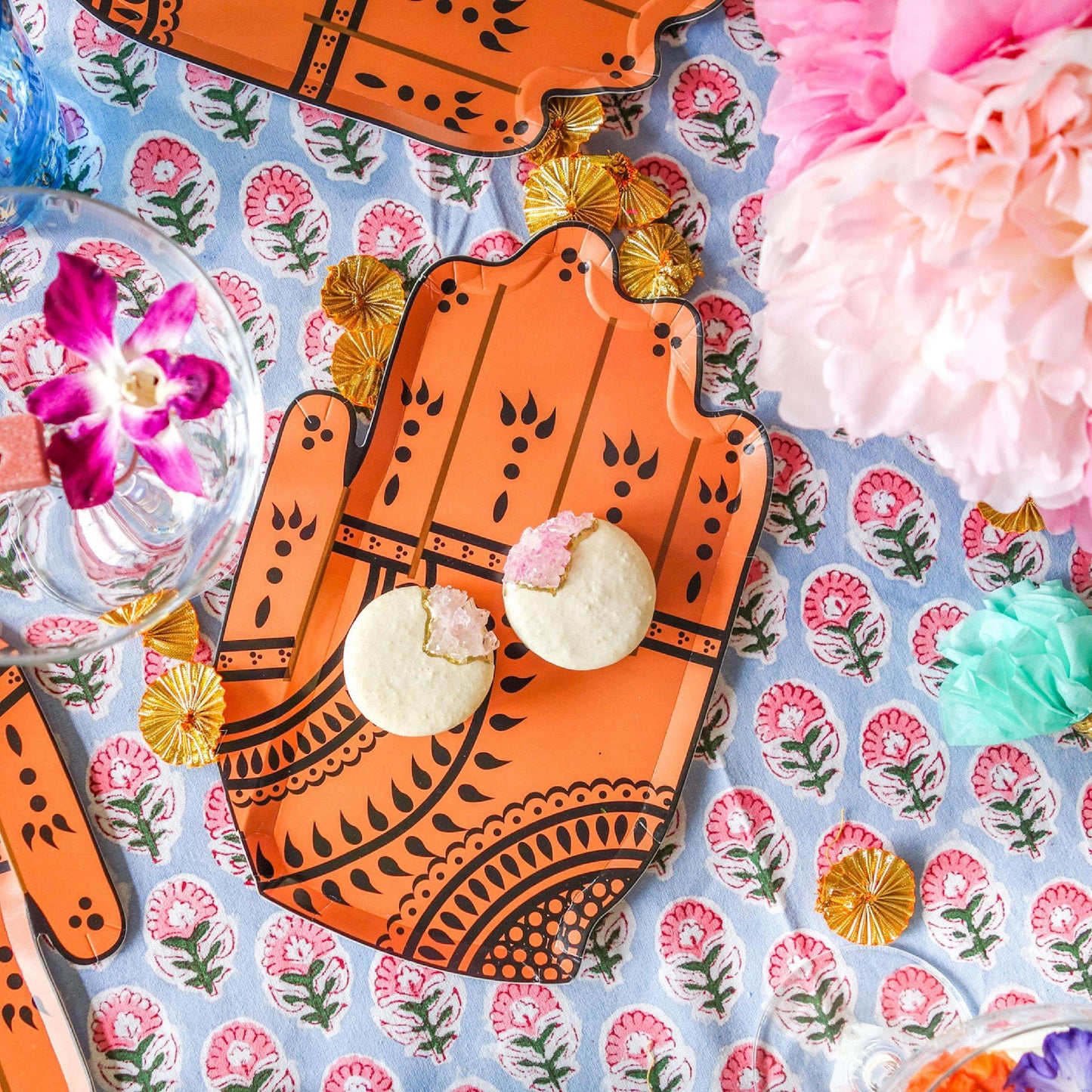 Flatlay of Henna Hand plate with geode macarons on top