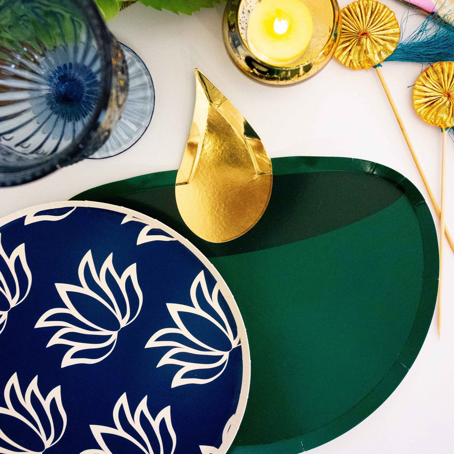 Diya party plate underneath blue lotus plate