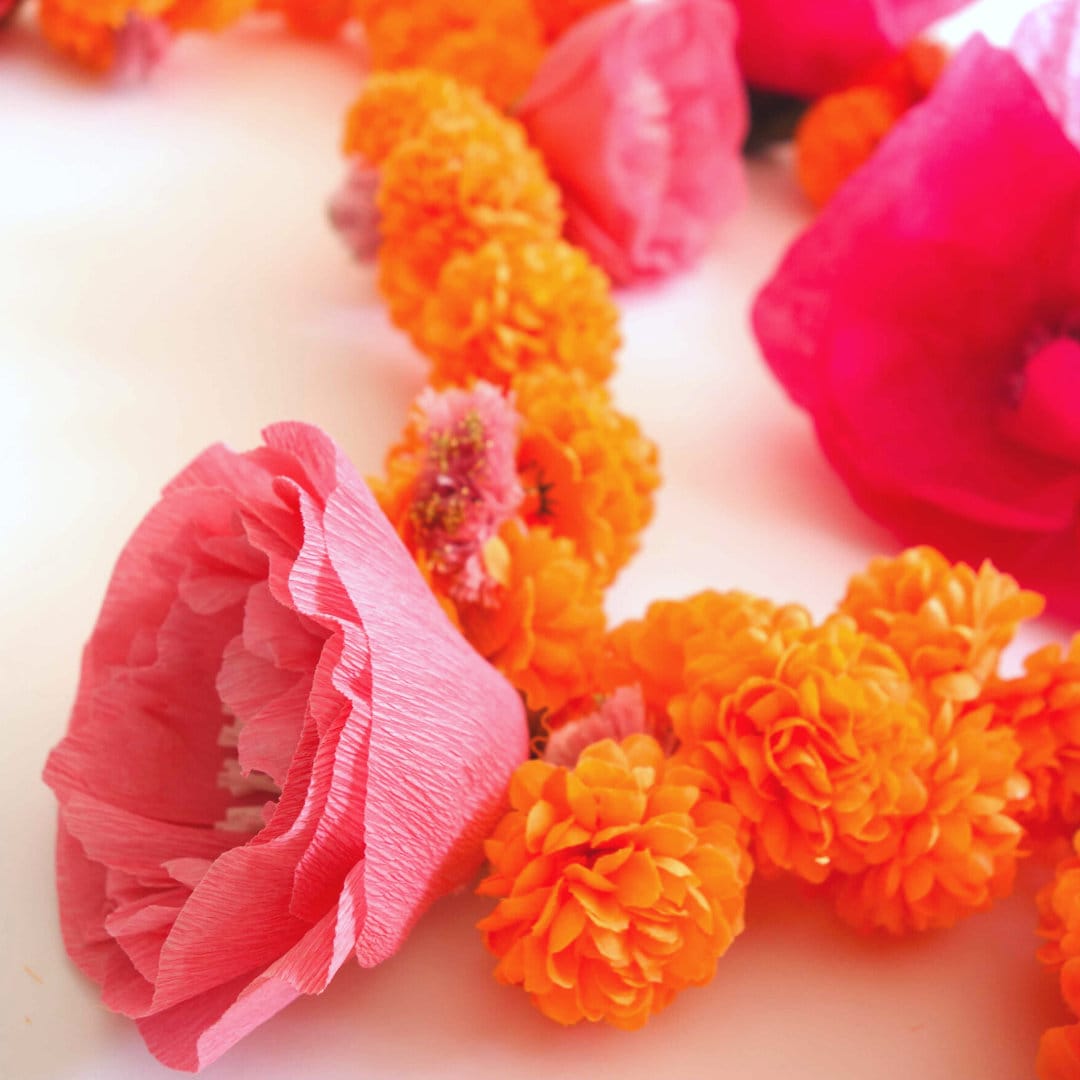 Side view of peony flower on marigold Diwali garland