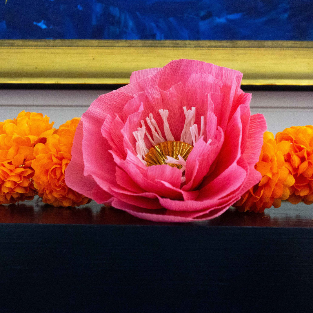 Close up of Lush Marigold garland sitting on top of mantle