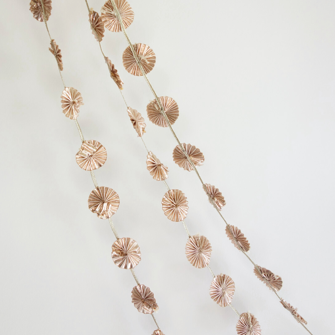 Close up of 3 strands of rose gold garlands
