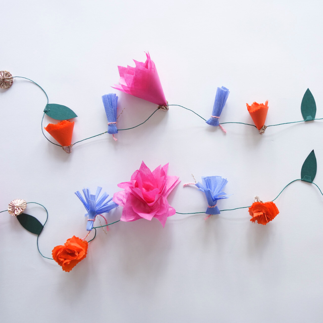 Side by side image of unfluffed and fluffed out paper Lotus Garland