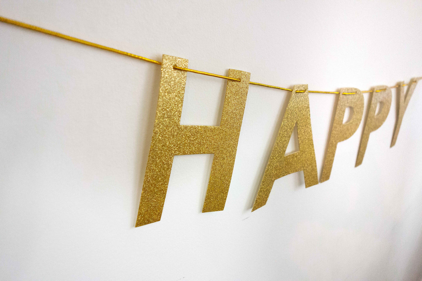 Close up of glitter letters on Happy Diwali banner