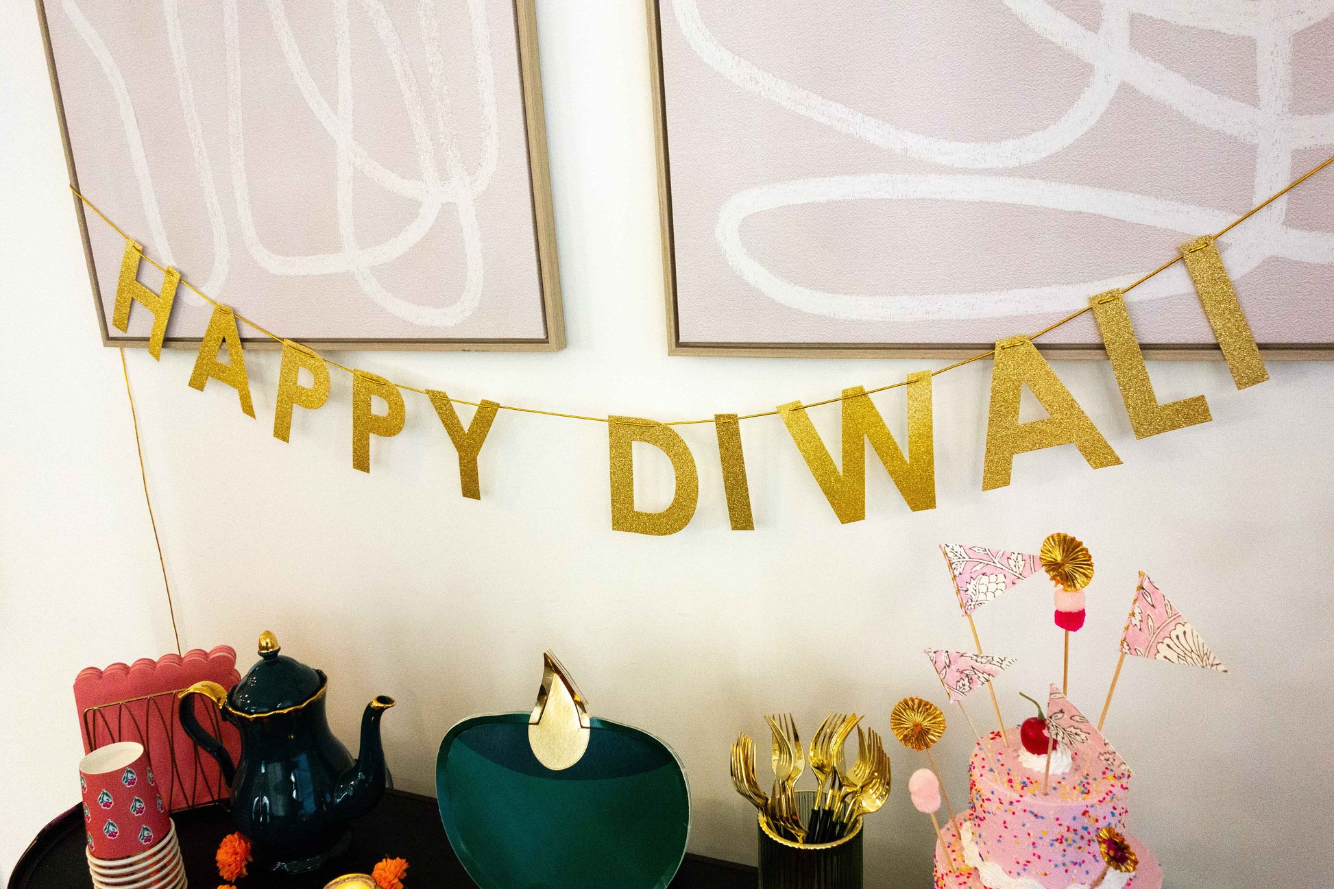 Happy Diwali banner hanging over dessert and tea table