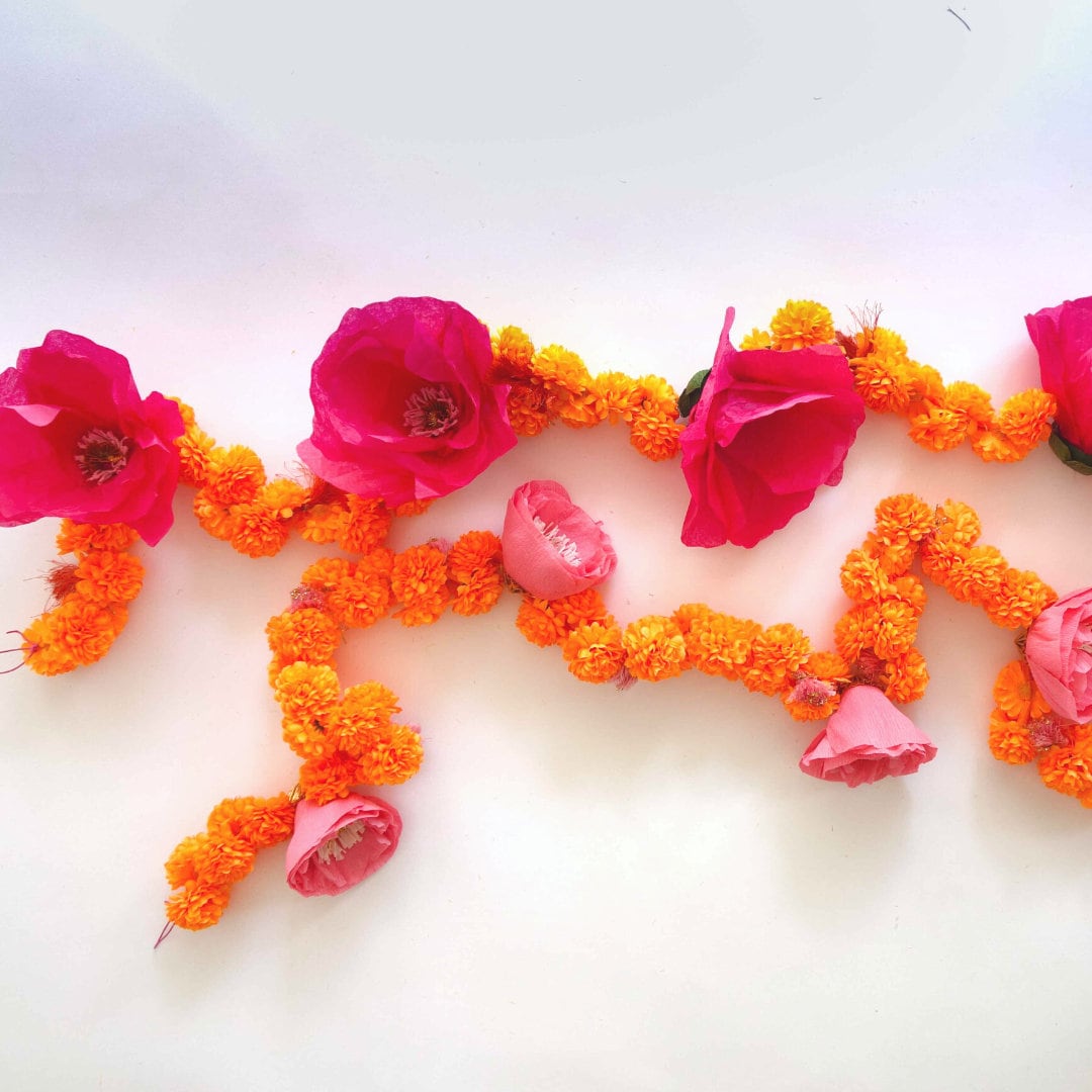 Overhead view of 2 set marigold garland with paper flowers