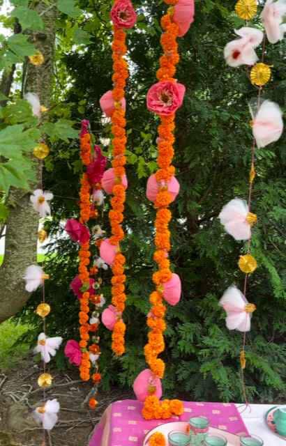 Multiple marigold garland sets hanging from trees